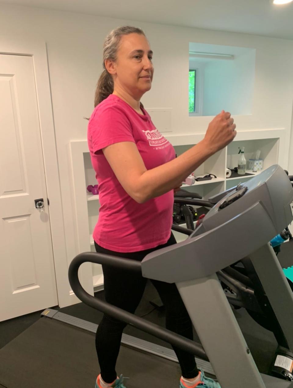 Jenny Berz, 50, walks on a treadmill as part of the COVID Bootcamp.