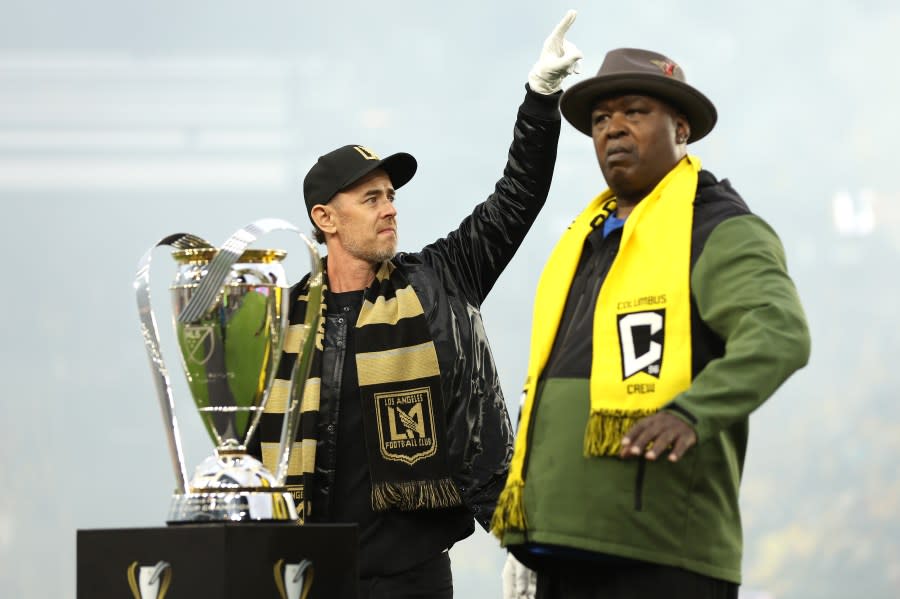 COLUMBUS, OHIO – DECEMBER 09: Colin Hanks (L) and Buster Douglas carry the Philip F. Anschutz Trophy to the field before the 2023 MLS Cup between the Columbus Crew and Los Angeles Football Club at Lower.com Field on December 09, 2023 in Columbus, Ohio. (Photo by Maddie Meyer/Getty Images)