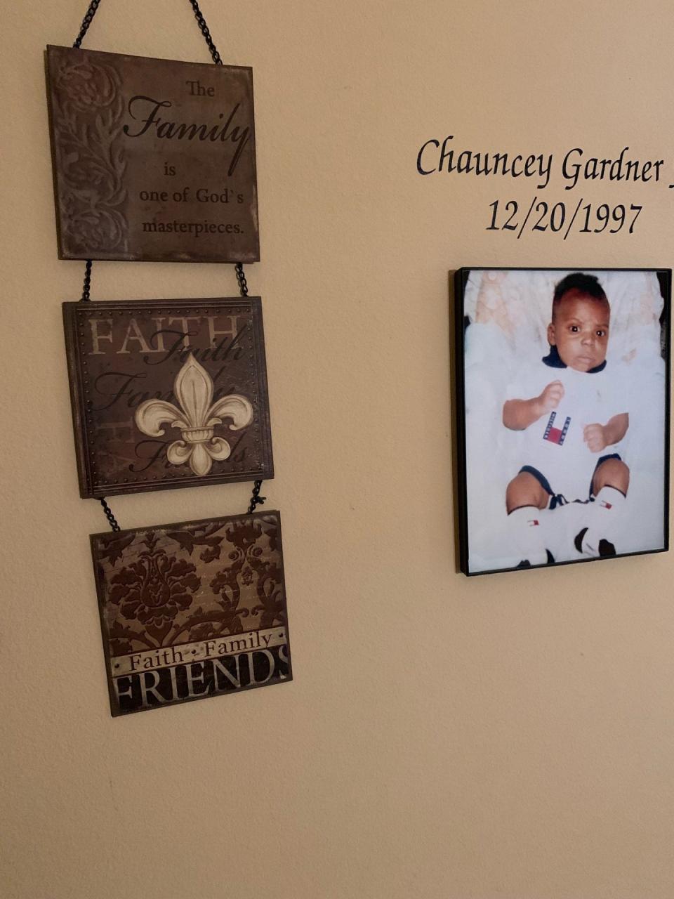 A photo of C.J. Gardner-Johnson when he was a baby next to a wall display.