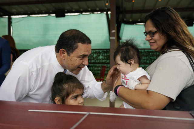 U.S. Rep. Henry Cuellar, D-Laredo, left, visits with Arielle Duran, right, and her family during a campaign event, Wednesday, May 4, 2022, in San Antonio. Cuellar, a 17-year incumbent and one of the last anti-abortion Democrats in Congress, is in his toughest reelection campaign, facing a May 24 primary runoff against progressive Jessica Cisneros. (AP Photo/Eric Gay)