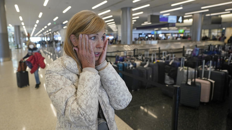 Chicago traveler Shana Schifer reacts after receiving her bags that had been lost since Christmas Day at the Southwest Airlines unclaimed baggage area at Salt Lake City International Airport Thursday, Dec. 29, 2022, in Salt Lake City. Southwest Airlines said it expects to return to normal operations Friday after slashing about two-thirds of its schedule in recent days, including canceling another 2,350 flights Thursday. (AP Photo/Rick Bowmer)