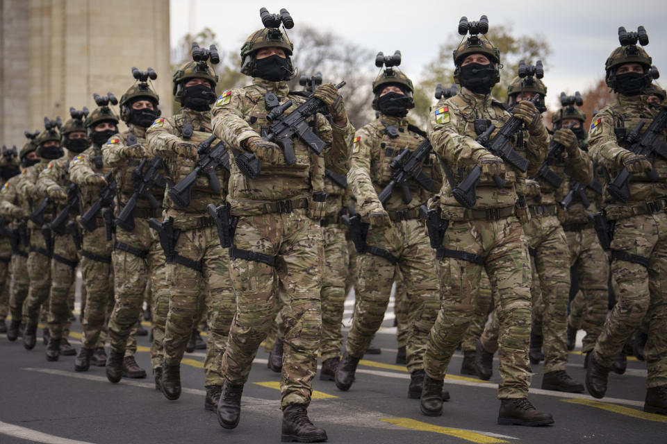 Members of a Romanian special operations unit march during the National Day parade in Bucharest, Romania, Friday, Dec. 1, 2023. Tens of thousands of people turned out in Romania's capital on Friday to watch a military parade that included troops from NATO allies to mark the country's National Day. (AP Photo/Vadim Ghirda)