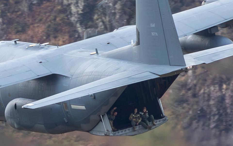 Personnel admire the view from a C-130 Hercules in the Mach Loop
