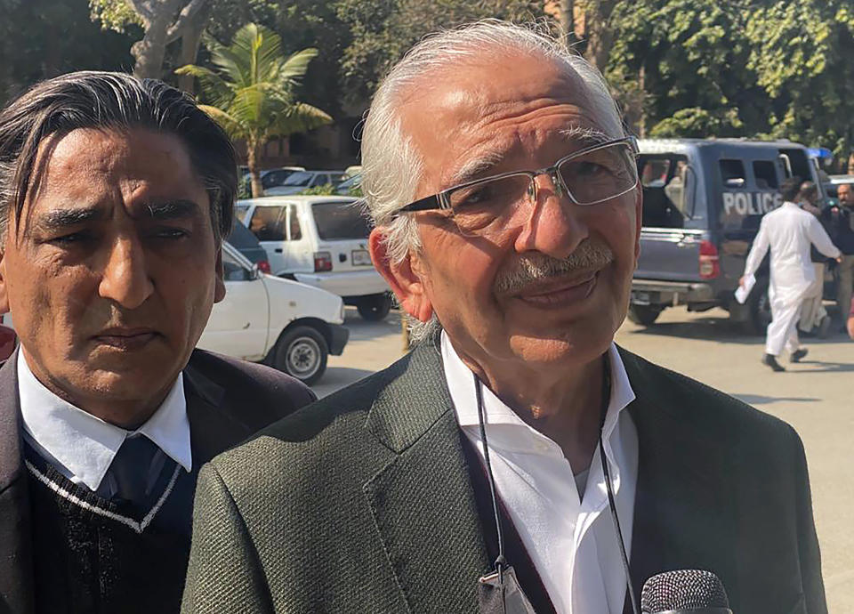 Mehmood A. Sheikh, right, a defense lawyer for British-born Pakistani Ahmed Omar Saeed Sheikh, who is charged in the 2002 murder of American journalist Daniel Pearl, talks to a journalists outside the Sindh High Court, in Karachi, Pakistan, Thursday, Dec. 24, 2020. The provincial court overturned a Supreme Court Decision that Sheikh should remain in custody during an appeal of his acquittal on charges he murdered Pearl. (AP Photo/Adil Jawad)