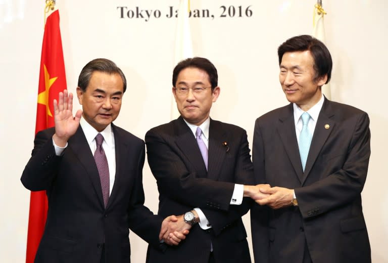 Japanese Foreign Minister Fumio Kishida (C), China's Wang Yi (L) and South Korea's Yun Byung-Se (R) met for dinner at a Tokyo hotel ahead of the start of formal talks on Wednesday