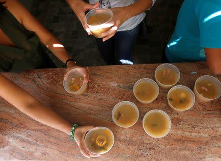 Teachers prepare soup for the students during an activity for the end of the school year at the Padre Jose Maria Velaz school in Caracas, Venezuela July 12, 2016. REUTERS/Carlos Jasso