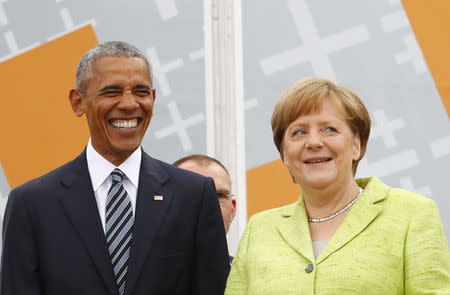 German Chancellor Angela Merkel and former U.S. President Barack Obama attend a discussion. REUTERS/Fabrizio Bensch