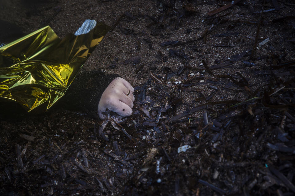 FILE - In this Sunday, Nov. 1, 2015 file photo, an unidentified woman wearing a wedding ring lies on a beach at the village of Skala, on the Greek island of Lesbos. Authorities recovered more bodies on Lesbos and the Greek island of Samos that day as thousands continue to cross from the nearby coast of Turkey despite worsening weather. (AP Photo/Santi Palacios)