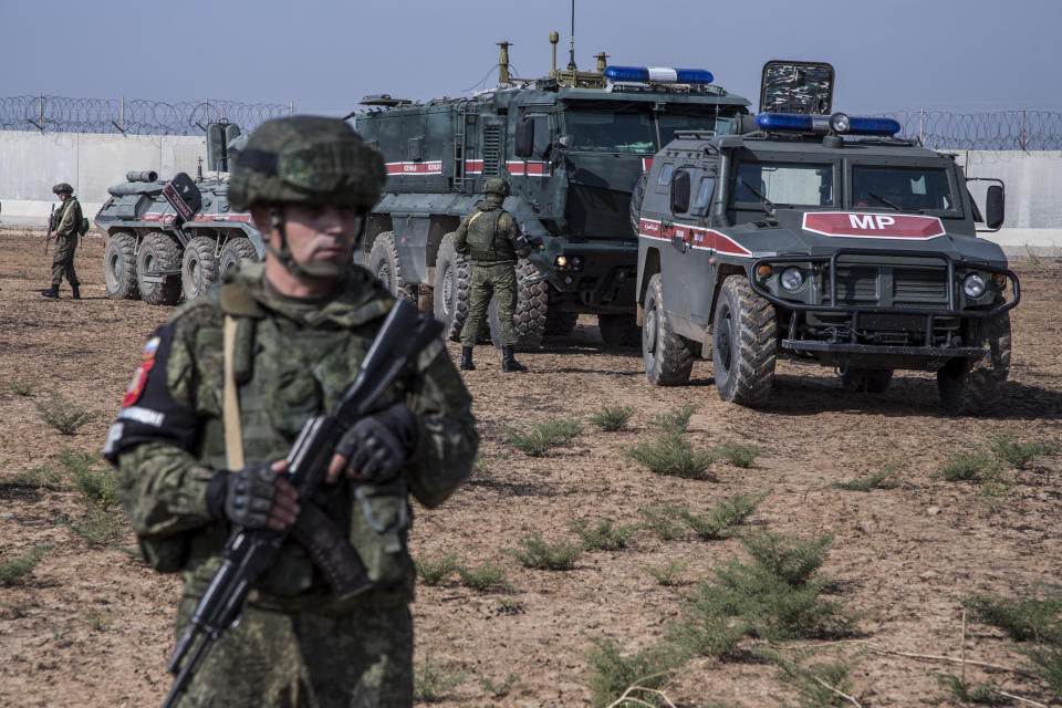 FILE - This Nov. 1, 2019 file photo, Turkish and Russian soldiers patrol near the town of Darbasiyah, Syria. A summit meeting between the Turkish and Russian leaders scheduled for Thursday, March 5, 2020, may be the last chance to work out a deal that avoids a calamity in Syria's northwest. Faced with mounting losses for his troops in Syria and a potential wave of refugees fleeing fighting in northwestern Syria, Turkish President Recep Tayyip Erdogan is eager for a cease-fire and Vladimir Putin is ready to bargain. (AP Photo/Baderkhan Ahmad, File)