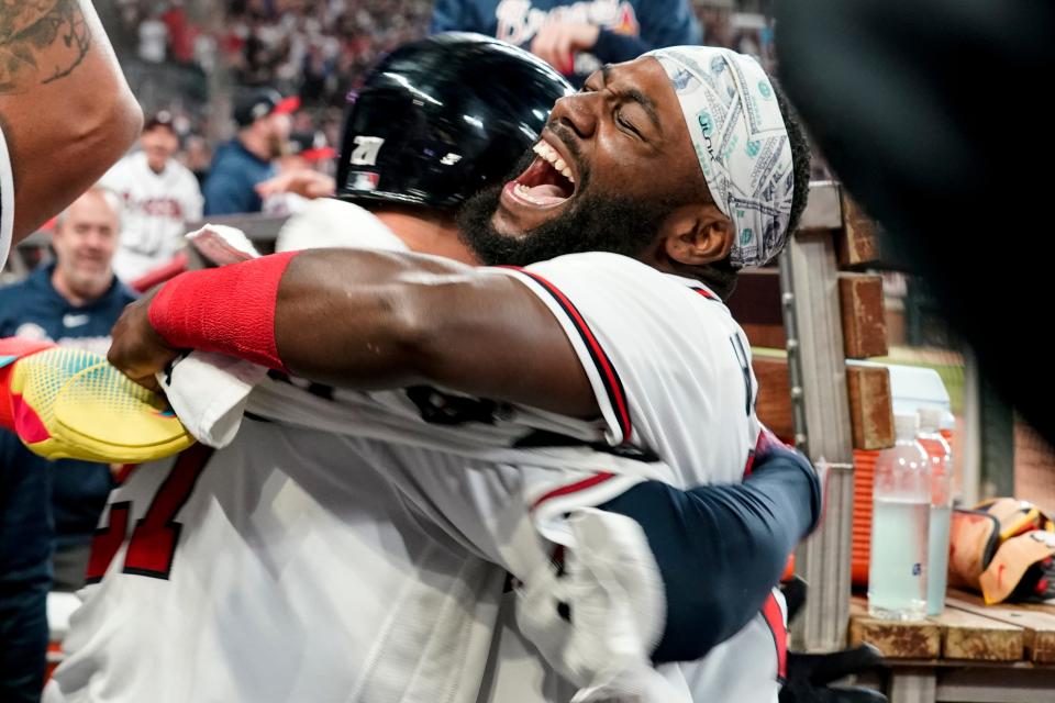 Atlanta Braves' Michael Harris II, right, celebrates with Austin Riley (27) after Riley hit a two-run homer in the dugout in the eighth inning of Game 2 of a baseball NL Division Series against the Philadelphia Phillies, Monday, Oct. 9, 2023, in Atlanta. (AP Photo/Brynn Anderson)