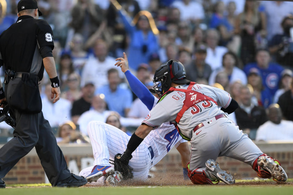 Chicago Cubs' Willson Contreras (40) scores as Cincinnati Reds catcher Aramis Garcia (33) applies a late tag during the first inning of a baseball game Wednesday, June 29, 2022, in Chicago. (AP Photo/Paul Beaty)