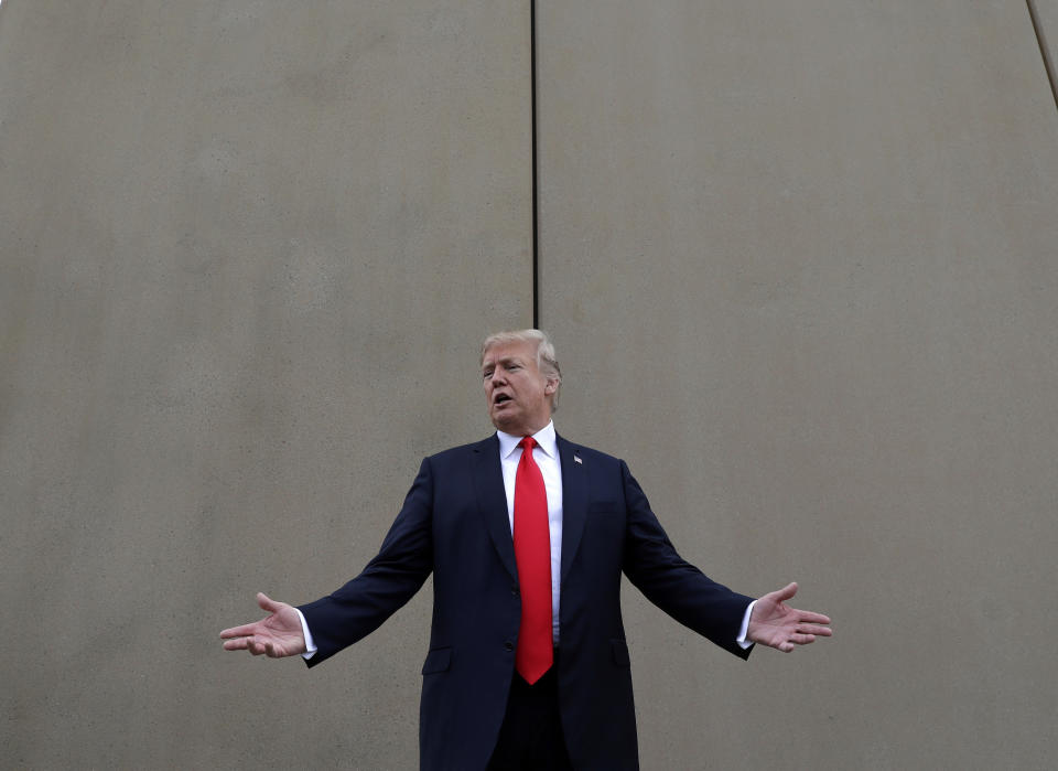 FILE - In this March 13, 2018, file photo, President Donald Trump speaks during a tour as he reviews border wall prototypes in San Diego. A relentless stream of U.S. policy shifts in 2018 has amounted to one of the boldest attacks on all types of immigration that the country has ever seen. Some see it as a tug-of-war between foundational national ideals and a fight for a new path forward led by Trump. (AP Photo/Evan Vucci, File)