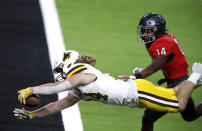 Wyoming running back Brett Brenton (24) dives into the end zone for a touchdown ahead of UNLV defensive back Tyson Player (14) during the second half of an NCAA college football game in Las Vegas on Friday, Nov. 27, 2020. (Steve Marcus/Las Vegas Sun via AP)