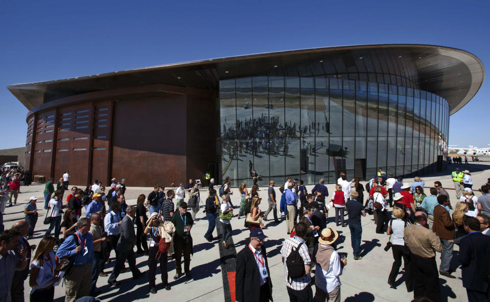 Guests stand outside the new Spaceport America hangar in Upham, N.M. (AP Photo/Matt York, File)