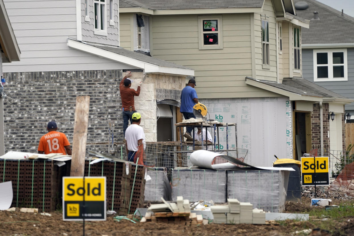 Construction workers build already sold new KB Homes in Houston. (Credit: David J. Phillip, AP Photo)