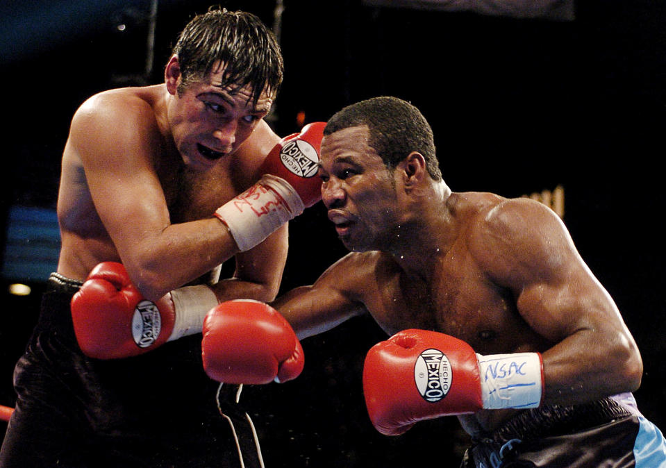 Shane Mosley works against Oscar De La Hoya during their 2003 bout. (AP)