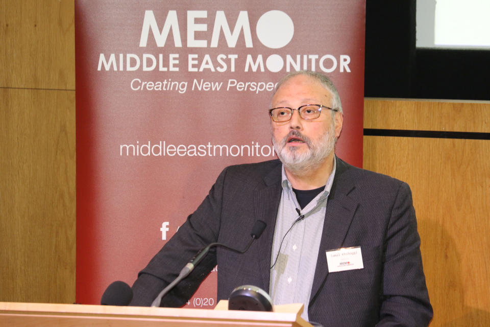 Jamal Khashoggi at the microphone at an event that, the sign behind him says: Memo, Middle East Monitor, Creating New Perspectives, middleeastmonitor.