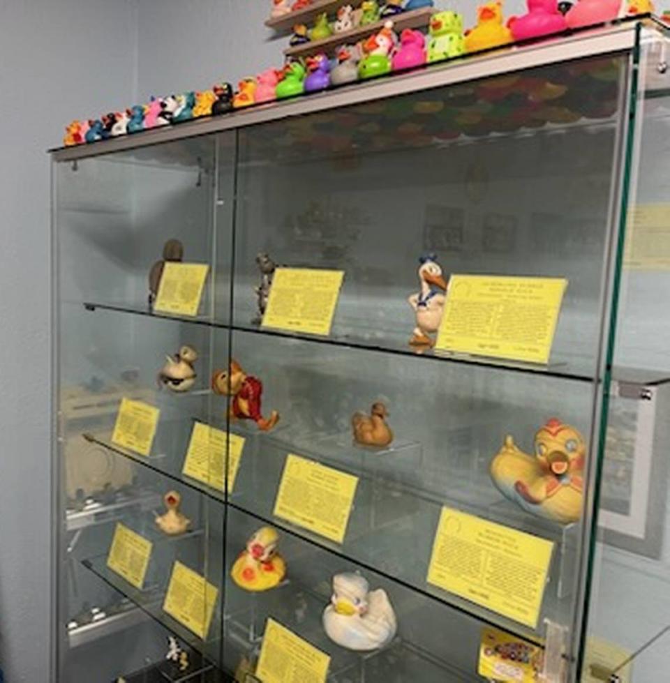 Several early rubber duck designs sit behind a display case at the Rubber Duck Museum in Point Roberts, Wash.