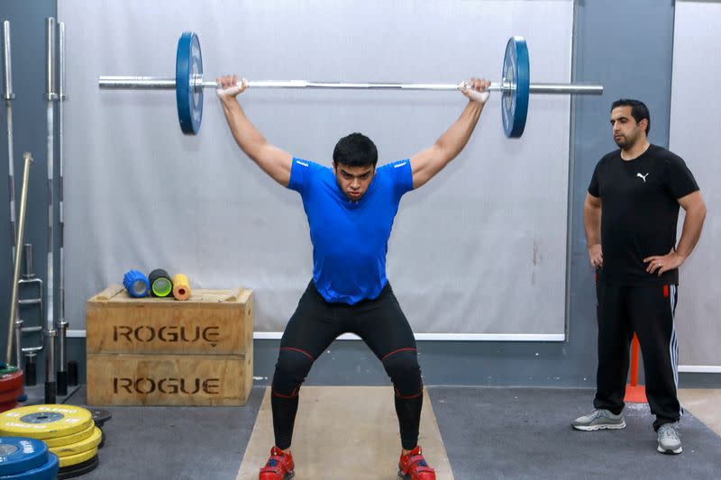 Gaza weight-lifter Mohammad Hamada who is the first Palestinian to compete in the game at the Olympics when it kicks off in Tokyo, practices at a gym in Doha