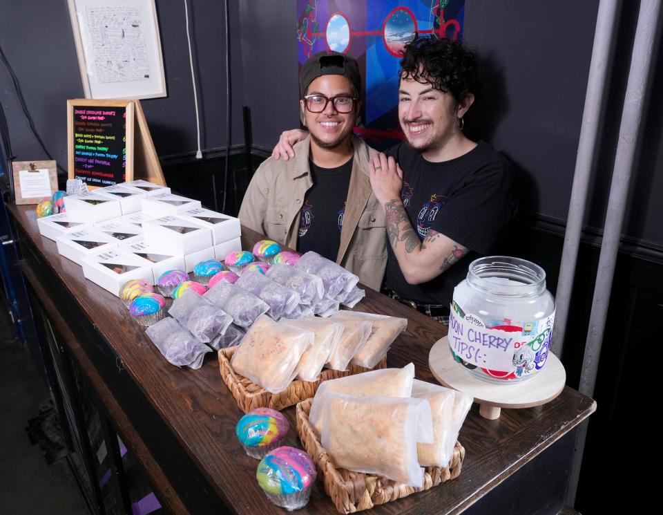 Chase Roldan, left, and his partner Jack Roldan, owners of Milwaukee's Moon Cherry Sweets, stand behind an assortment of sweets at their plant-based pop-up bakery at the Cactus Club in Milwaukee on Sunday, July 31, 2022. They participate in the Trans People of Color Eat Free movement. At Moon Cherry, trans people of color are always able to eat free. The bakery pops up at Cactus Club on Sundays.