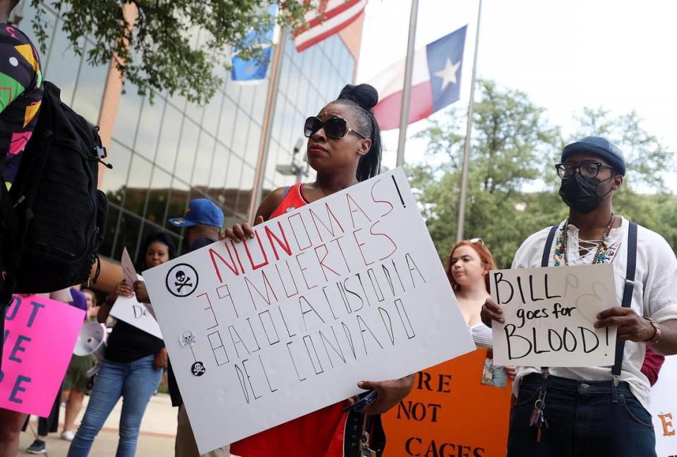 Shanelle Jenkins holds a sign during a rally outside the Tarrant County commissioners meeting on May 10, 2022
