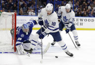 Toronto Maple Leafs left wing Andreas Johnsson (18) deflects a pass to center Auston Matthews (34) in front of Tampa Bay Lightning goaltender Andrei Vasilevskiy (88) during the first period of an NHL hockey game Thursday, Dec. 13, 2018, in Tampa, Fla. (AP Photo/Chris O'Meara)