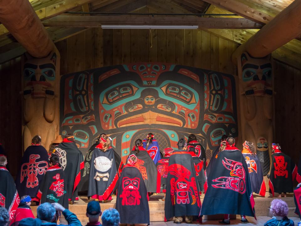 Alaska Natives in red and black clothes