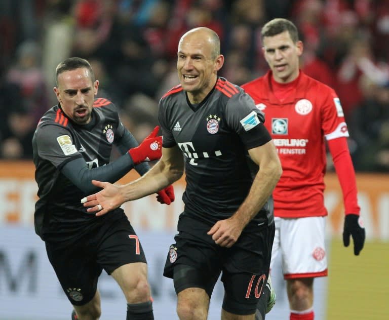 Bayern Munich's midfielder Arjen Robben celebrates scoring the 2-1 goal with Bayern Munich's midfielder Franck Ribery (L) during the German first division Bundesliga football match between FSV Mainz 05 and FC Bayern Munich December 2, 2016