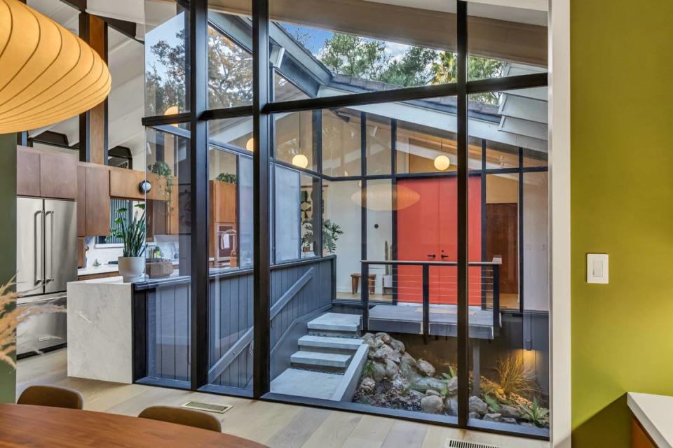 The atrium leads to the front door of the California modern home for sale in Fair Oaks.