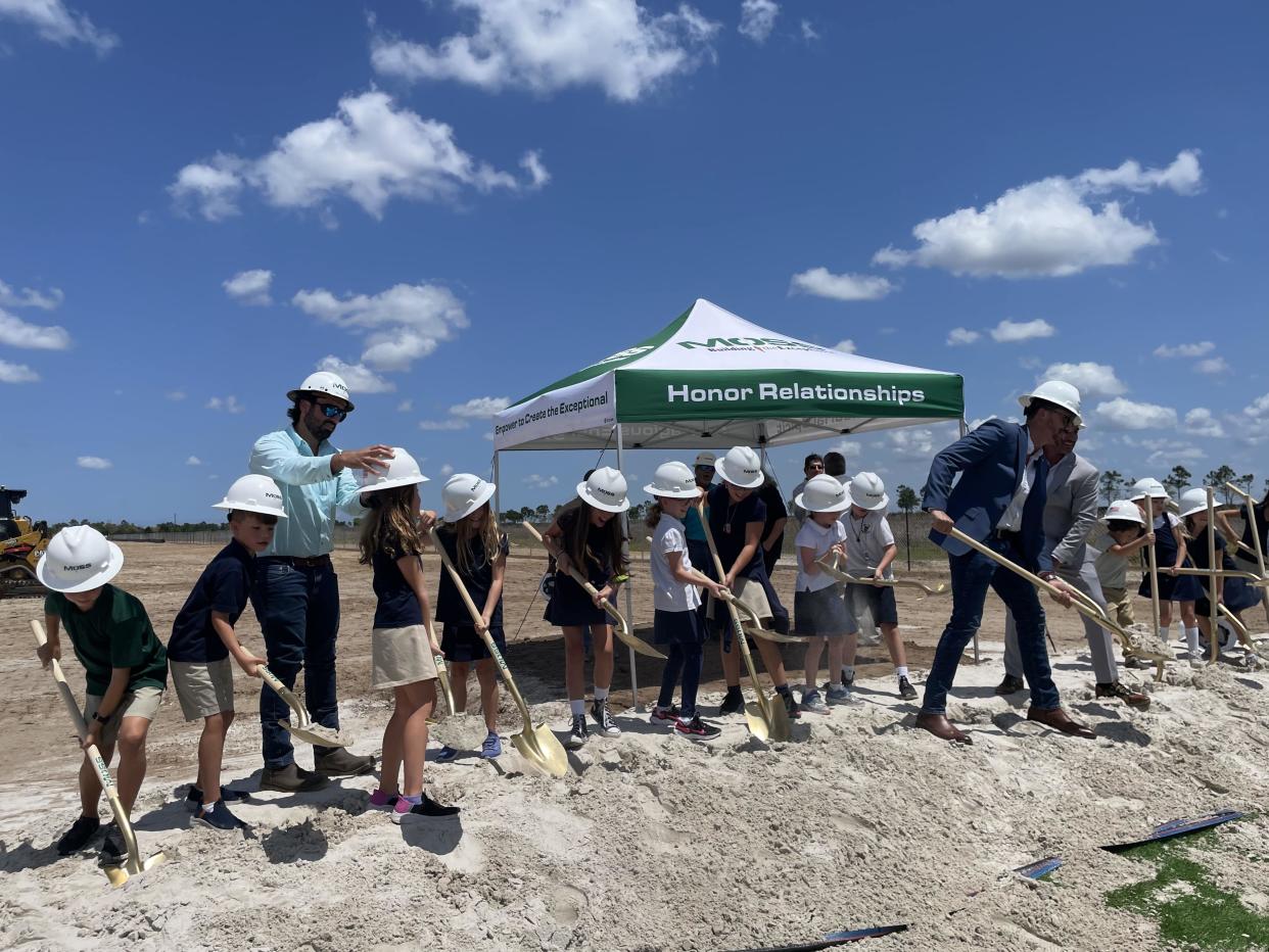 Children from Binks Forest Elementary participate in a ceremonial groundbreaking for the new West Acreage Elementary School off Southern Boulevard near Arden.