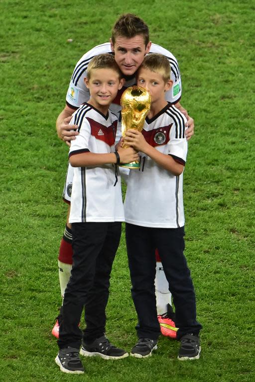 Germany's forward Miroslav Klose (C) celebrates with his sons after winning the 2014 FIFA World Cup final football match between Germany and Argentina at the Maracana Stadium in Rio de Janeiro on July 13, 2014