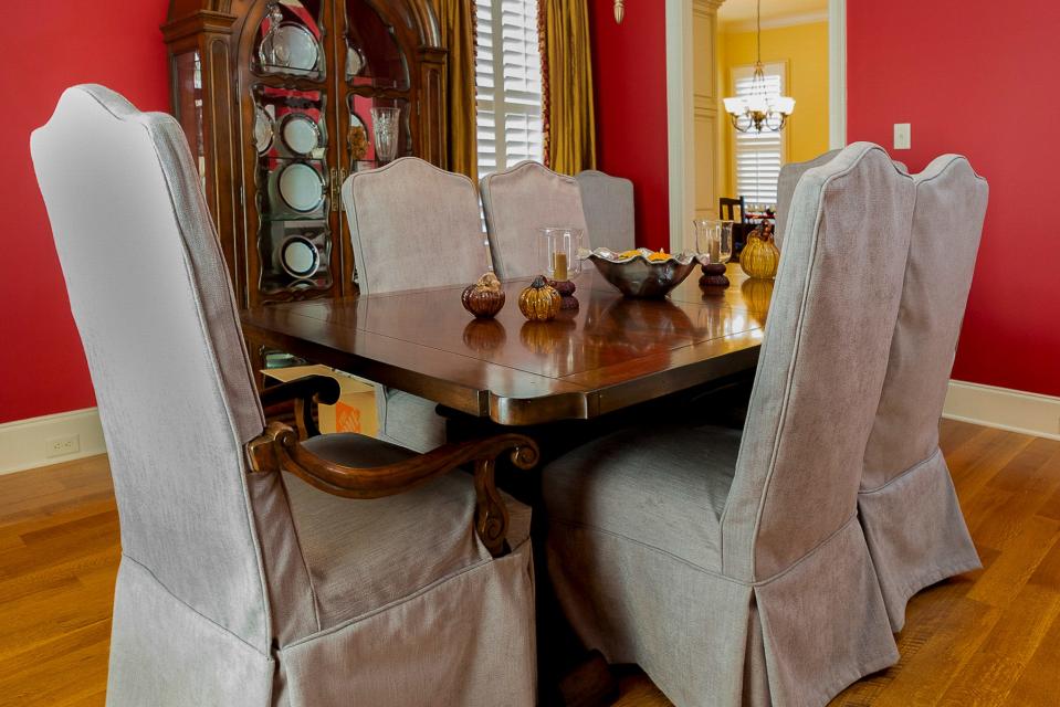 The dining room’s terracotta color scheme adds a bold tone to the room.