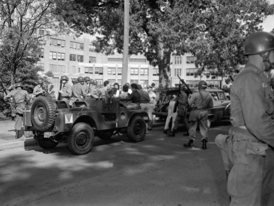 Arkansas National Guardsmen stand guard at Little Rock's Central High School in 1957