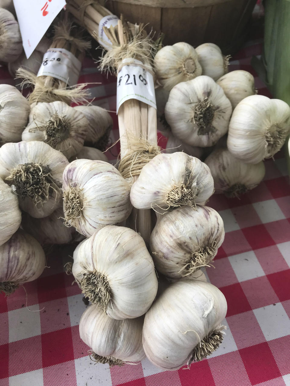 Garlic bulbs are displayed at a farmer's market in Waitsfield, Vt., on Aug. 28, 2021. Signing up for a Community-Supported Agriculture program means getting a box of produce from local farms every week or two. It's a great way to take advantage of summer's bounty, discover new fruits and vegetables, and support the folks who grow food in your area. (AP Photo/Carolyn Lessard)