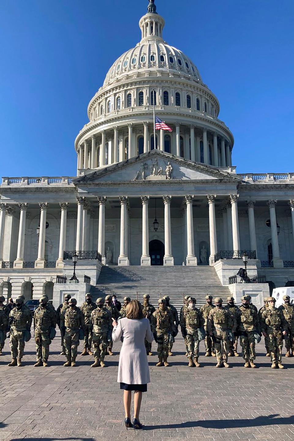 In this image released by the Speaker of the House Nancy Pelosi's Office, Pelosi speaks to National Guard troops outside the U.S. Capitol on Wednesday, Jan. 13, 2021, in Washington.