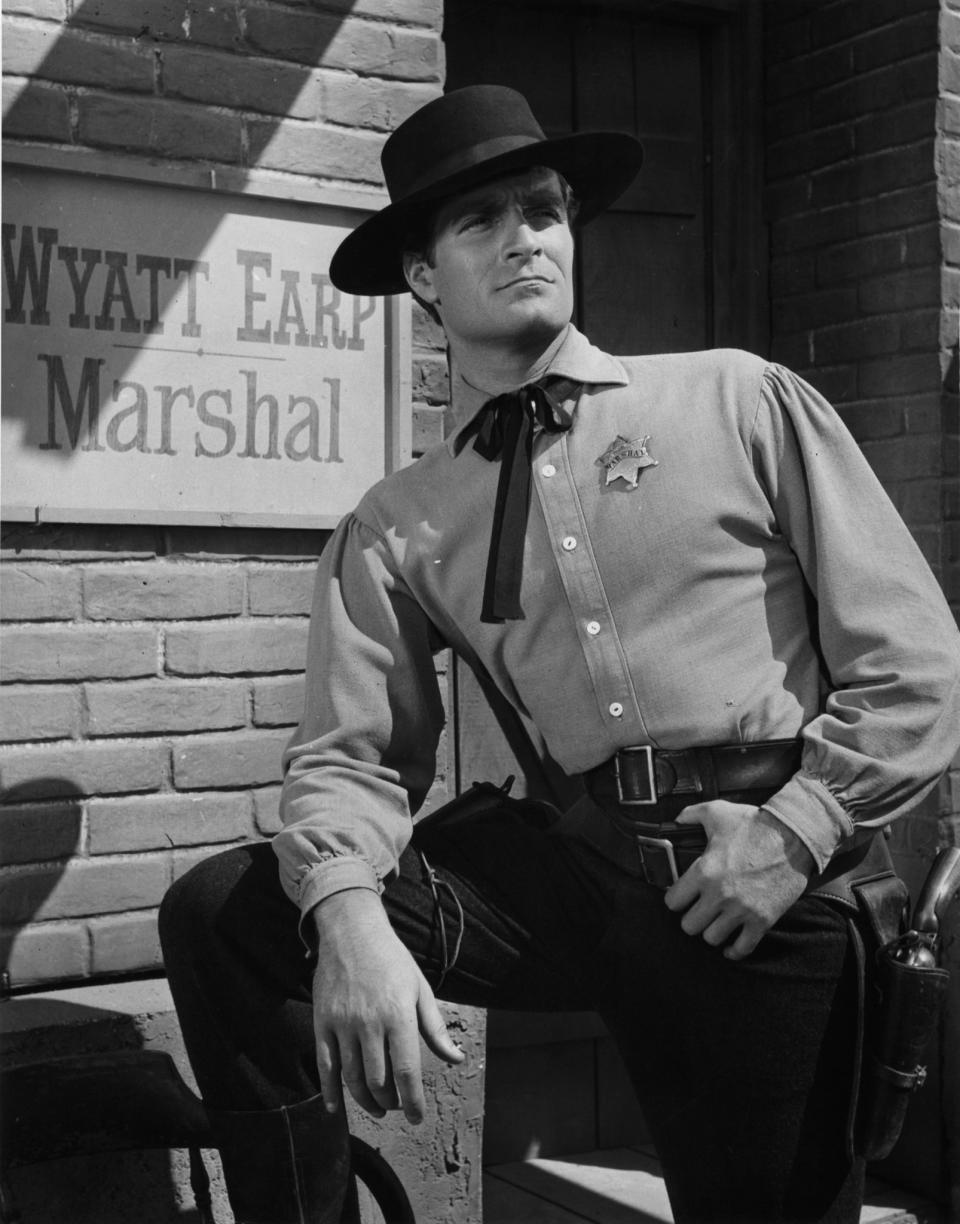 <p>Best known for his role in The Life and Legend of Wyatt Earp, died on September 6 at age 91. — (Pictured) Hugh O’Brian standing before his sign in a scene from the television series ‘The Life And Legend of Wyatt Earp’, 1955. (ABC/Getty Images) </p>