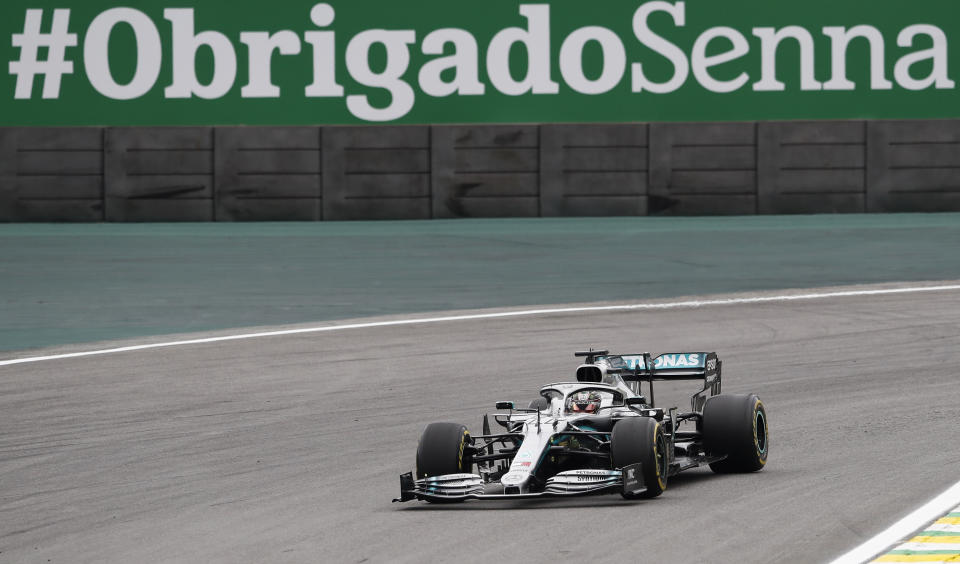 Mercedes driver Lewis Hamilton, of Britain, steers his car during the second free practice at the Interlagos race track in Sao Paulo, Brazil, Friday, Nov. 15, 2019. The banner in Portuguese reads: ''#Thank you Senna'' in honor of the three-time FIA Formula One World Champion Ayrton Senna. (AP Photo/Nelson Antoine)