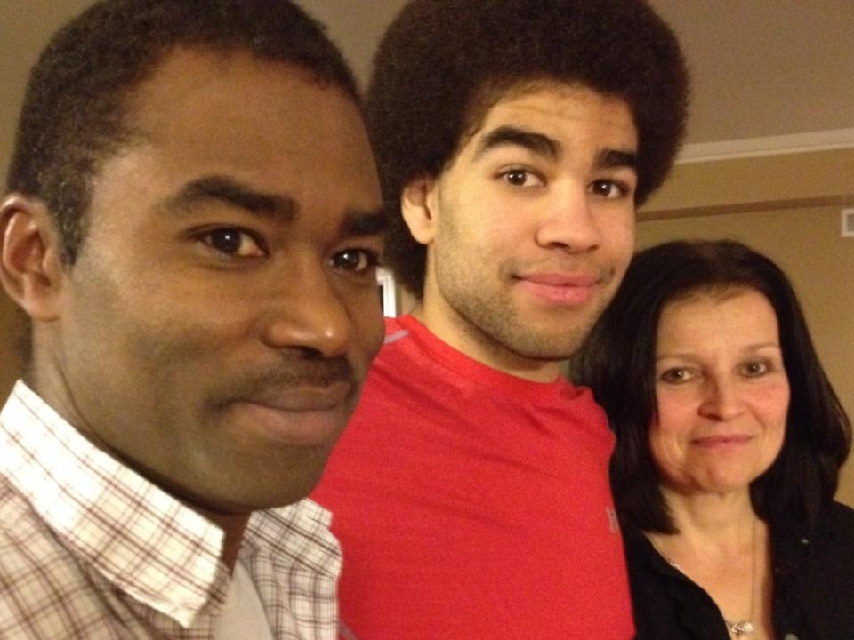 Neil Doef, centre, is seen with his father Bruce Doef and mother Bobbi-Jean Doef in 2015. This was one year after he fractured his seventh cervical vertebra when he was checked into the boards by an opponent. (Hallie Cotnam/CBC - image credit)