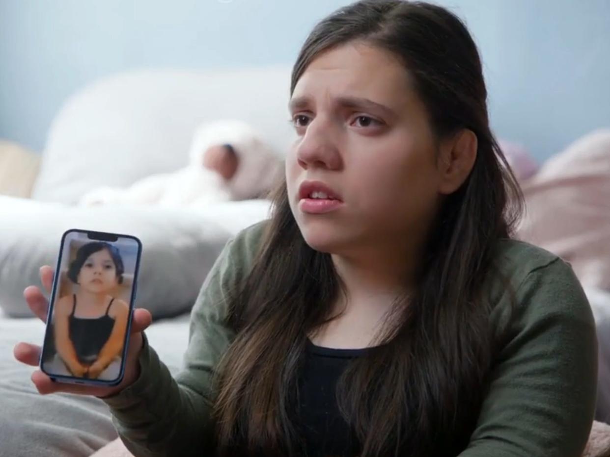 Natalia Grace holds a phone showing a photo of herself age 7 in makeup on "The Curious Case of Natalia Grace: Natalia Speaks."