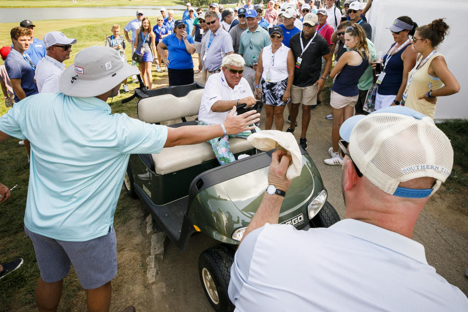 Fans surround John Daly near the 18th green during the PGA Barbasol Championship second round at Keene Trace Golf Club Champions Course in Nicholasville, Ky., Friday, July 19, 2019. (Alex Slitz/Lexington Herald-Leader via AP)