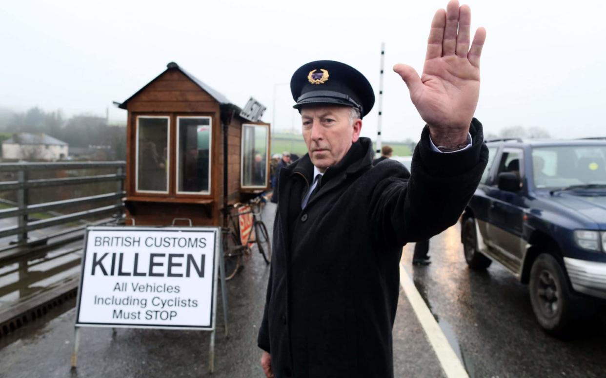 Demonstrators dressed as custom officials set up a mock customs checkpoint at the border crossing in Killeen, near Dundalk  - AFP