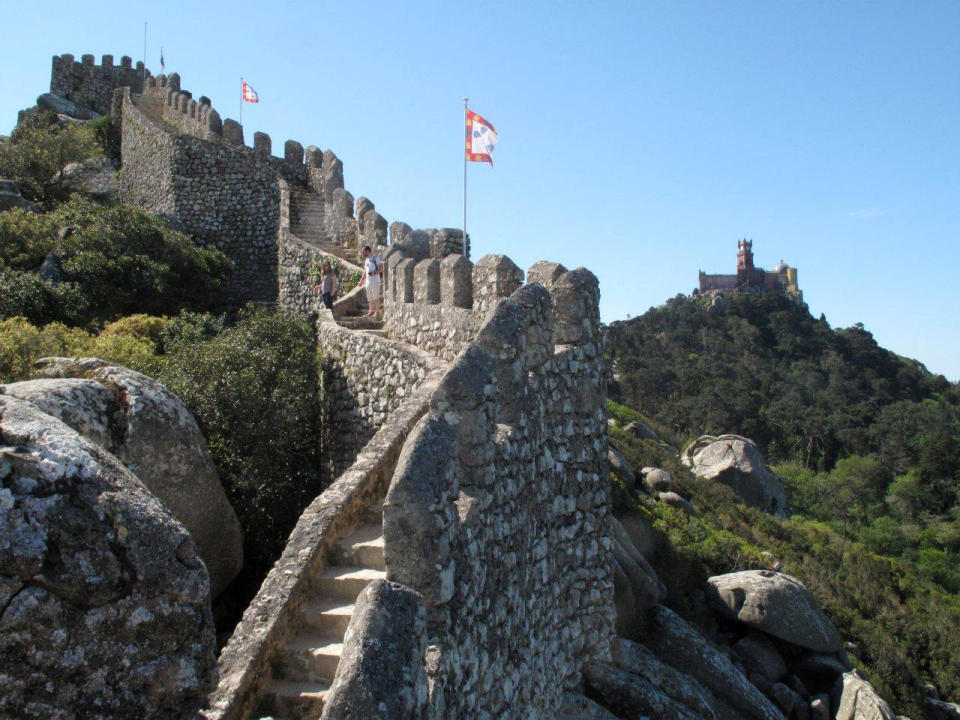 This May 2013 photo shows Pena Palace in the distance with the steps of the Moorish Castle in the foreground in Sintra, Portugal. Sintra, located near the Portuguese capital of Lisbon, has long been a playground of royalty and is home to a number of spectacular castles and other buildings. (AP Photo/Mike Corder)