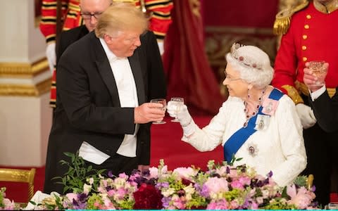 Donald Trump and the Queen make a toast at Buckingham Palace in June - Credit: Getty