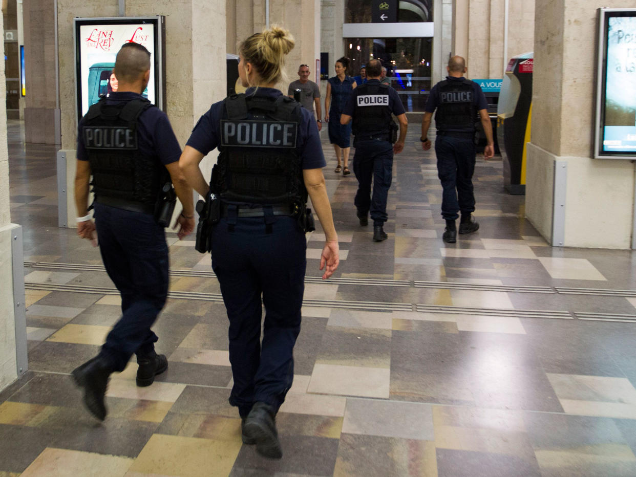 Passengers and police officers walk in the train station of Nimes after it was reopen on August 19, 2017: AFP/Getty Images