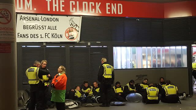 Police officers take a break outside the Emirates Stadium 