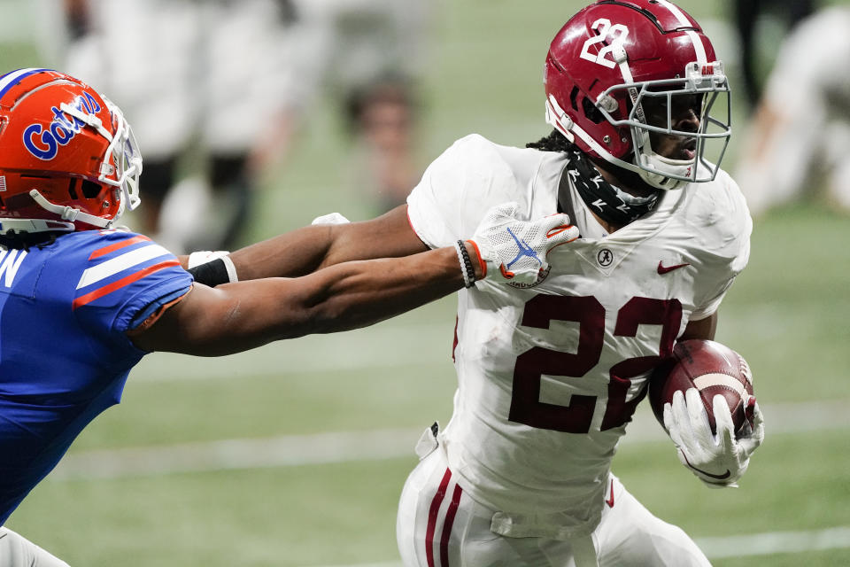 FILE - In this Saturday, Dec. 19, 2020 file photo, Alabama running back Najee Harris (22) runs into the end zone for a touchdown against Florida during the first half of the Southeastern Conference championship NCAA college football game in Atlanta. Brandon Beane didn’t entirely rule out the possibility of adding a running back in the first two rounds, with Clemson’s Travis Etienne and Alabama’s Najee Harris rated as the top prospects (AP Photo/John Bazemore, File)