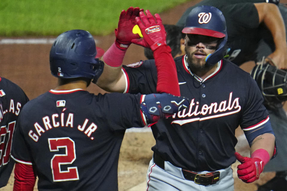 Washington Nationals' Andrés Chaparro, right, celebrates with Luis García Jr. (2) as he returns to the dugout after hitting a two-run home run off Pittsburgh Pirates relief pitcher Ryan Borucki during the seventh inning of the second baseball game of a doubleheader in Pittsburgh, Saturday, Sept. 7, 2024. (AP Photo/Gene J. Puskar)