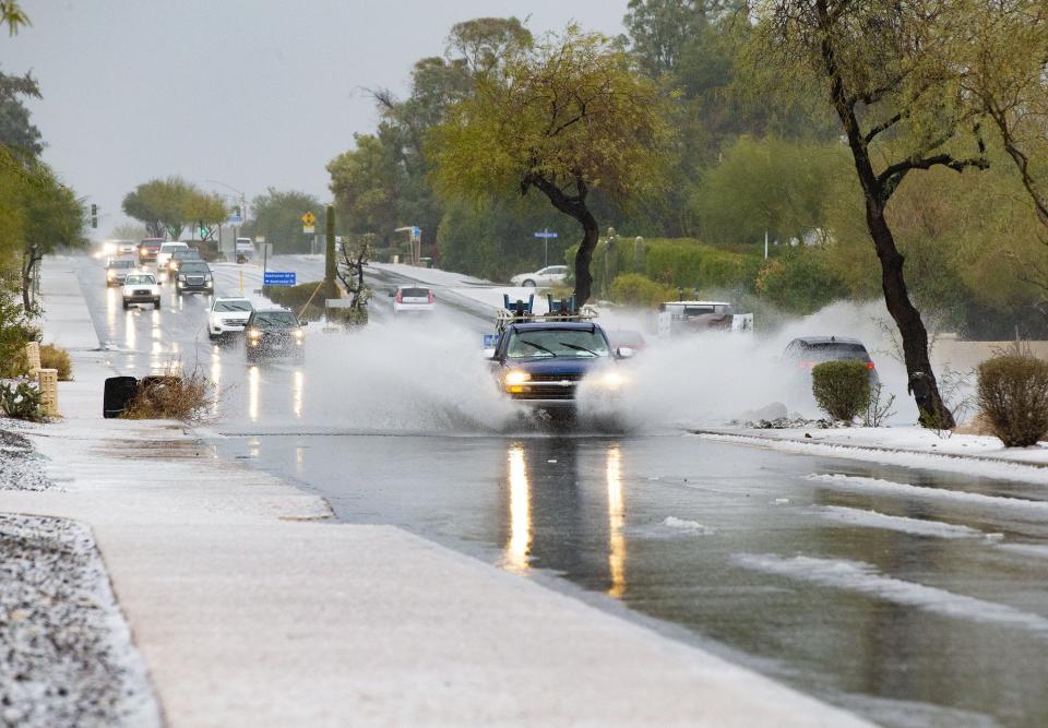 Cars drive through melting graupel and hail on Tatum Blvd. in Paradise Valley during a winter storm on Jan. 25, 2021.