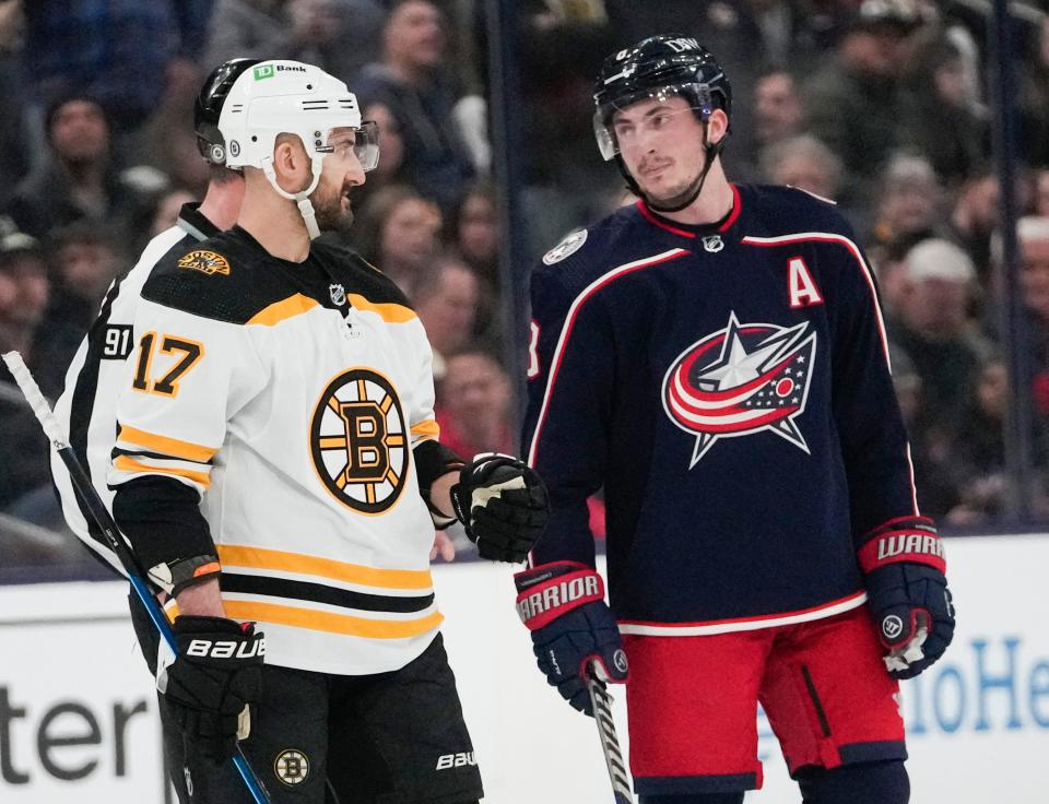 Mon., Apr. 4, 2022; Columbus, Ohio, USA; Boston Bruins left wing Nick Foligno (17) and Columbus Blue Jackets defenseman Zach Werenski (8) talk after a hit on Columbus Blue Jackets defenseman Andrew Peeke, not pictured, forced a stop in play during the first period of a NHL game between the Columbus Blue Jackets and the Boston Bruins at Nationwide Arena. Mandatory Credit: Joshua A. Bickel/Columbus Dispatch