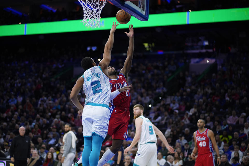 Philadelphia 76ers' Buddy Hield (17) goes up for a shot against Charlotte Hornets' Grant Williams (2) during the first half of an NBA basketball game, Friday, March 1, 2024, in Philadelphia. (AP Photo/Matt Slocum)